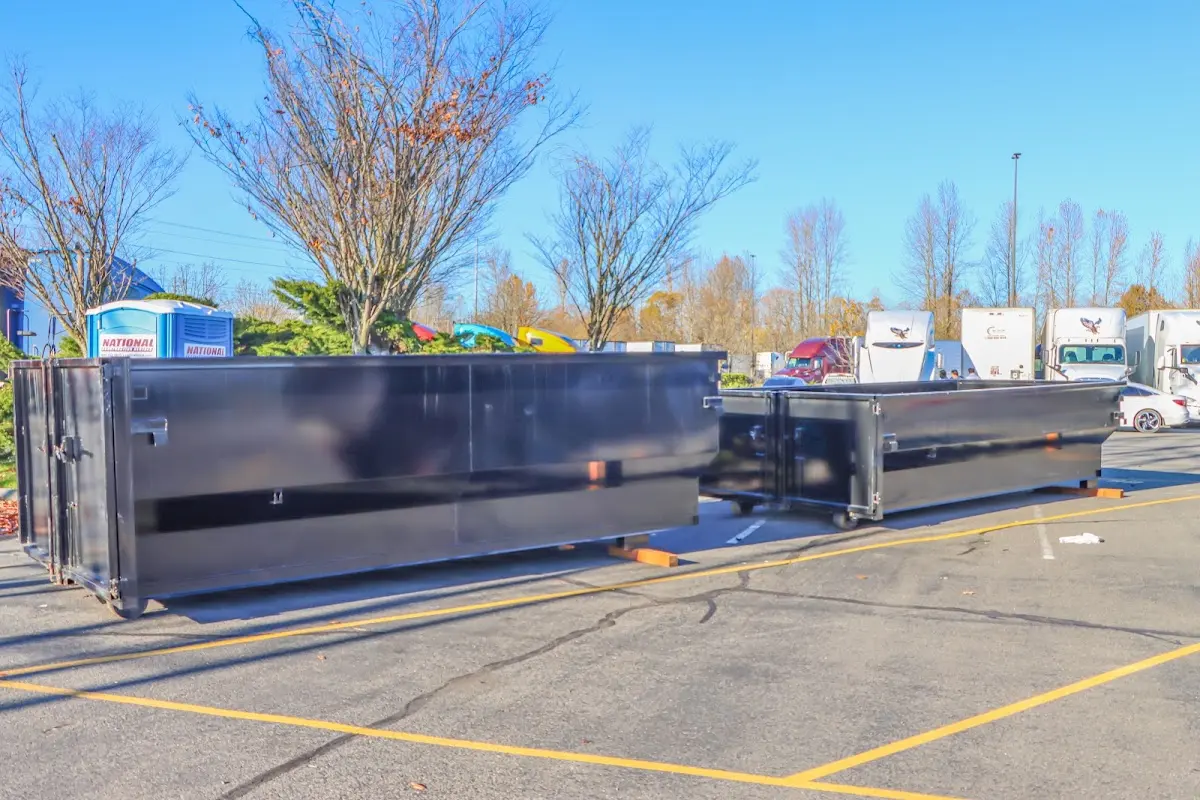 Professional dumpster rental service with roll-off container on residential driveway in Fernley